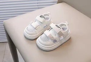 Detail showing white mesh breathable toddler sandals with Velcro strap and 1987 label