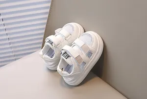 Detail of white mesh toddler sandals with dual hook-and-loop straps and anti-slip rubber sole