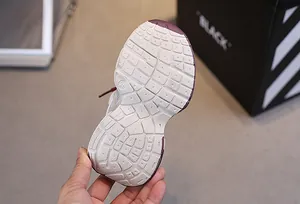 Detail view of anti-slip rubber outsole for kids sneakers with embossed size 26 marking