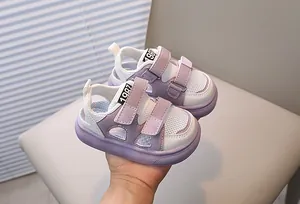 Detail of purple and white mesh toddler sandals featuring double velcro straps and soft sole