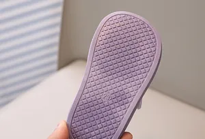 Detail of purple toddler sandal sole featuring non-slip grid texture and size 23 mark