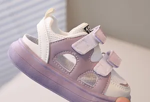 Close-up of purple breathable mesh baby sandals with dual hook and loop straps