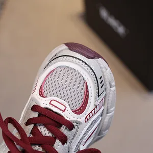 Kids breathable mesh sneakers in white and grey with red accents and athletic dad shoe style