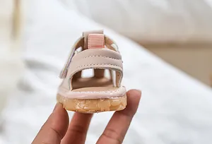 Detailed view of pink toddler sandals with non-slip cartoon bear rubber soles