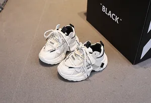 Overhead shot of breathable mesh kids sneakers with white and black synthetic leather panels