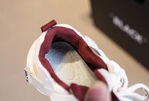Detail view of breathable red mesh lining and cushioned insole of children's sneaker