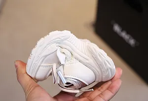 Detail showing the ultra-flexible sole of a white breathable mesh toddler sneaker