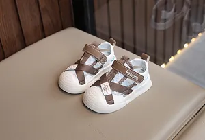 Detail of baby summer sandals featuring breathable mesh and brown leather with velcro strap