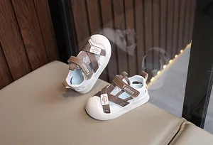 Detail of baby summer sandals featuring breathable mesh, leather straps and rubber soles