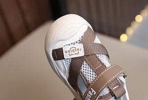 Close-up of baby mesh sandals showing breathable fabric, bear patch and velcro strap