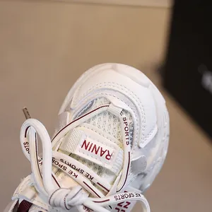 White kids breathable mesh sneakers with synthetic leather panels and lace-up design