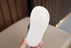 Detail of baby shoe rubber sole with anti-slip pyramid texture and size 18 mark