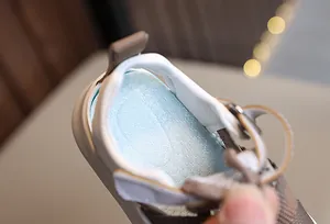 Detail of baby sandal showing breathable blue anti-slip insole and soft beige leather edge