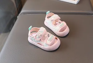 Detail von rosa Babysandalen mit Steppmuster, Cartoon-Bär und Klettverschluss-Riemen