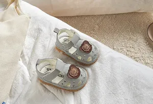 Detail of baby summer sandal with cute 3D bear decoration and breathable star-shaped holes