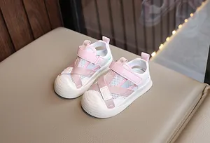 Detail of pink mesh toddler sandals with protective rubber toe cap and velcro strap