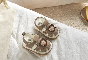 Detailed view of baby summer sandals featuring cartoon bear motifs and non-slip rubber soles
