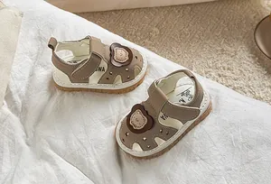 Close-up of toddler sandals featuring cartoon bear, star cutouts and anti-slip sole