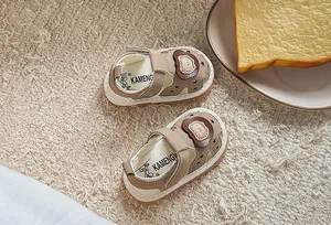 Detail of baby summer sandals featuring cute cartoon bear and star print on soft soles