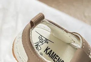 Close-up of baby sandal heel with soft leather stitching and cute panda logo detail