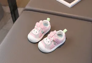 Close-up of pink breathable mesh baby shoes with protective white toe cap and cute bunny