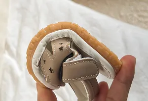 Close-up of flexible soft sole and star cutout design on baby summer sandals