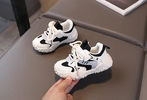 Detail of children's black and white breathable mesh sneakers with hook-and-loop straps