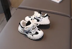 Detail of kids black and white breathable mesh sneakers with hook-and-loop strap