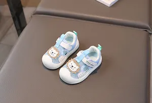 Detail of baby summer sandal with breathable mesh and cute lion cartoon patch