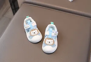 Detail view of baby mesh sandals featuring a cute lion patch and breathable mesh fabric