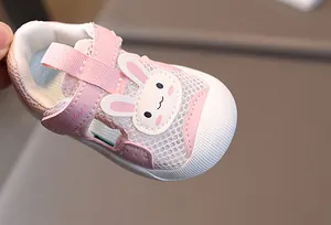 Close-up of pink baby sandal with breathable mesh, rabbit embroidery, and velcro strap