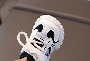 Detail of kids breathable mesh sneaker with classic black and white synthetic leather panels