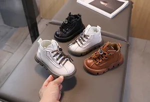 Detailed view of child leather boots with elastic drawstring laces and non-slip thick soles