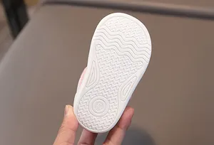 Close-up of baby walking shoe sole with non-slip wavy pattern and size 15 engraving