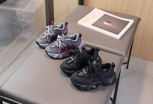 Detail of kids chunky sneakers featuring hook-and-loop straps and thick soles