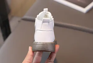 Detailed back view of white leather children boots featuring a sturdy non-slip rubber sole
