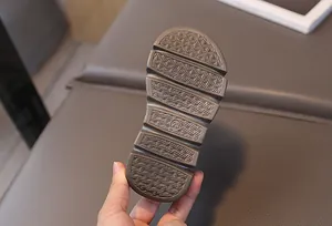 Close-up of children's non-slip rubber sole with size 23 marking and textured grip