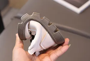 Close-up showing the extreme flexibility and soft leather of these white kids boots