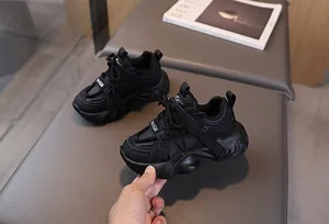 Detail of chunky black sneakers featuring mesh texture and anti-slip thick soles