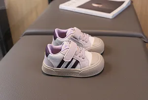 Detail view of toddler sneakers showing purple panels and non-slip rubber soles