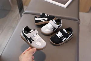 Close-up of kids trainers featuring non-slip rubber soles and Velcro straps for daily wear