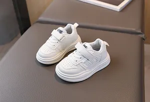 Détail de baskets blanches pour enfants avec bande velcro et cuir synthétique respirant