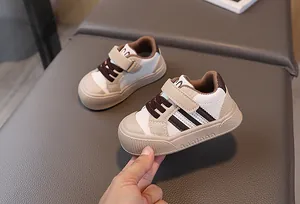 Macro detail of toddler sneaker showing velcro strap and classic three-stripe design