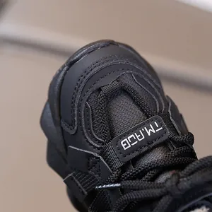 Kids' fashion black sports sneaker featuring mesh panels and lettered webbing detail