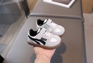 Detail of toddler sneaker with velcro strap and non-slip rubber gum sole in grey