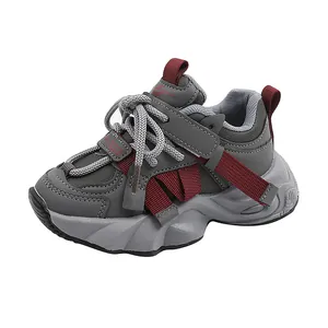 Kids chunky sneakers in grey with red accents and mesh leather upper on white background