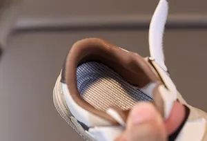 Detail of breathable mesh lining and padded collar on toddler sneakers for comfort