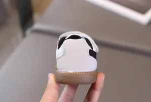 Detail of non-slip rubber outsole and suede heel on children's retro sneakers