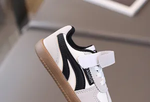 Detailed side view of kids sneakers featuring retro gum soles and fashion velcro straps