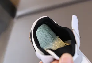 Detail of breathable green mesh insole and cushioned heel of kids' sport sneaker